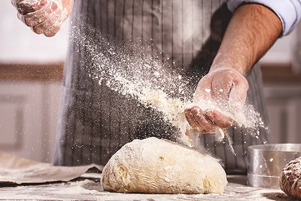 Chef kneading dough