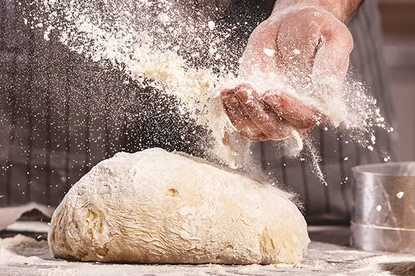 Chef kneading dough